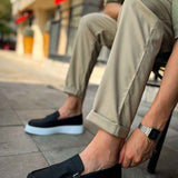 Black loafers with buckle strap and light blue sole, side angle view