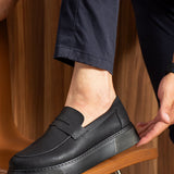 Men's black slip-on loafers with stitched strap vamp and low-profile sole