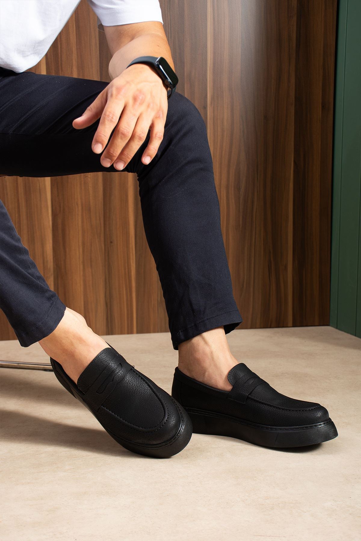 Men's black slip-on loafers, stitched top strap and smooth low sole, side view