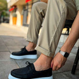 Men's casual black lace-up shoes with light blue rubber sole, side profile