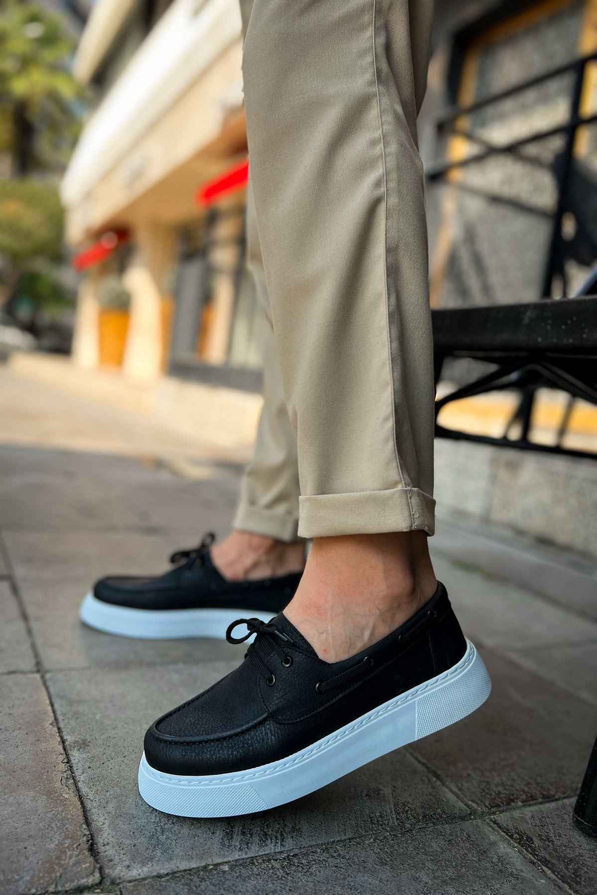 Men's casual black lace-up sneakers with light blue sole and round toe