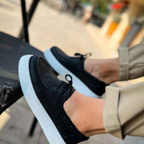 Men's casual black lace-up sneakers, close-up front with light blue sole