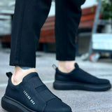 Men's casual dark slip-on sneakers with padded collar and textured rubber sole