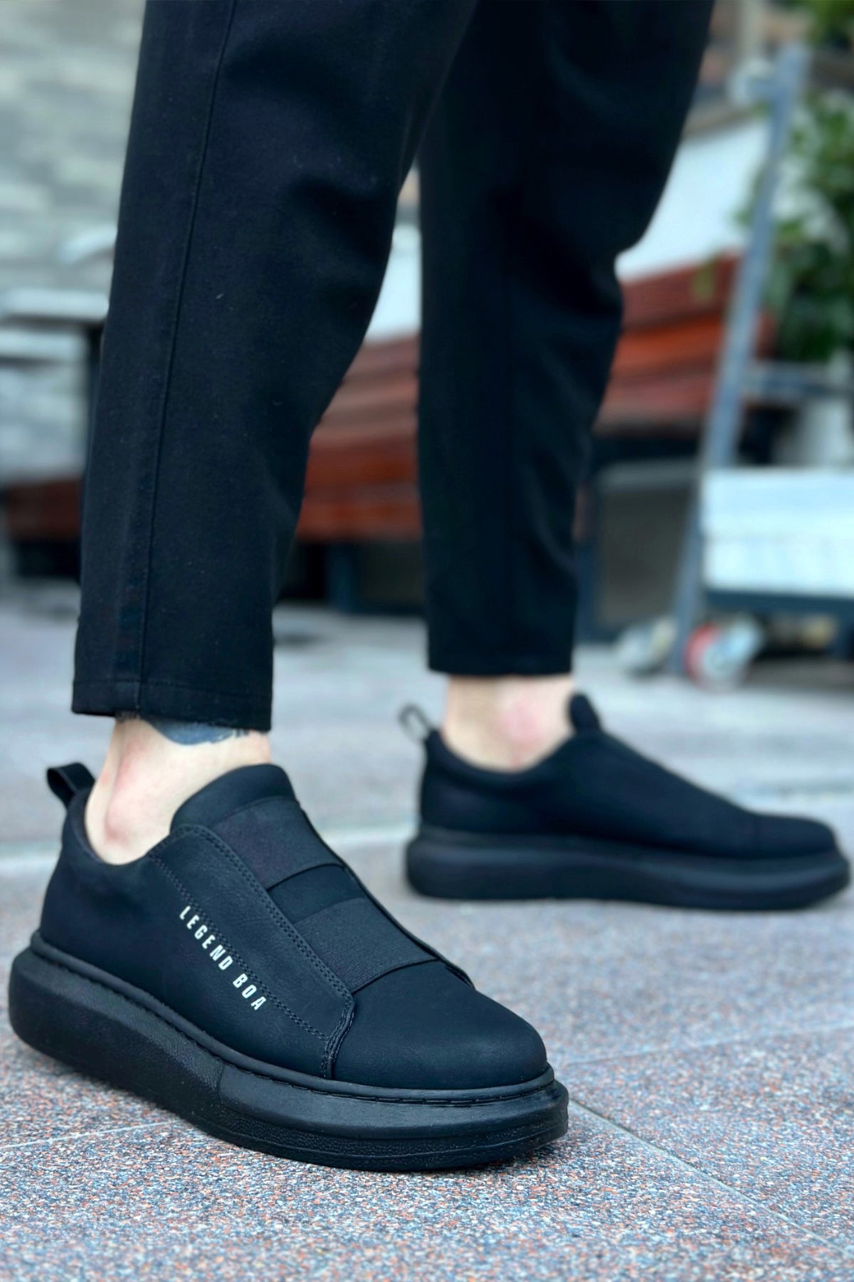 Men's casual dark slip-on sneakers with padded collar and textured rubber sole