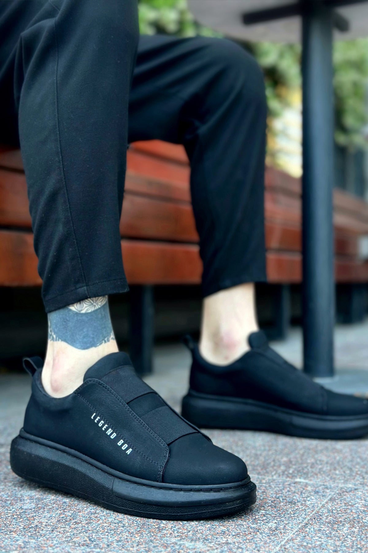 Men's casual dark sneakers, side view with elastic panel and cushioned sole