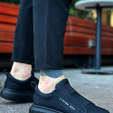 Men's casual dark low-top sneakers with side logo detail and thick rubber outsole