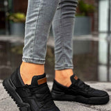 Men's black low-top sneakers with orange logo patch, hook-and-loop straps