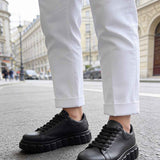 Men's casual black sneakers with lace-up front and thick, textured sole