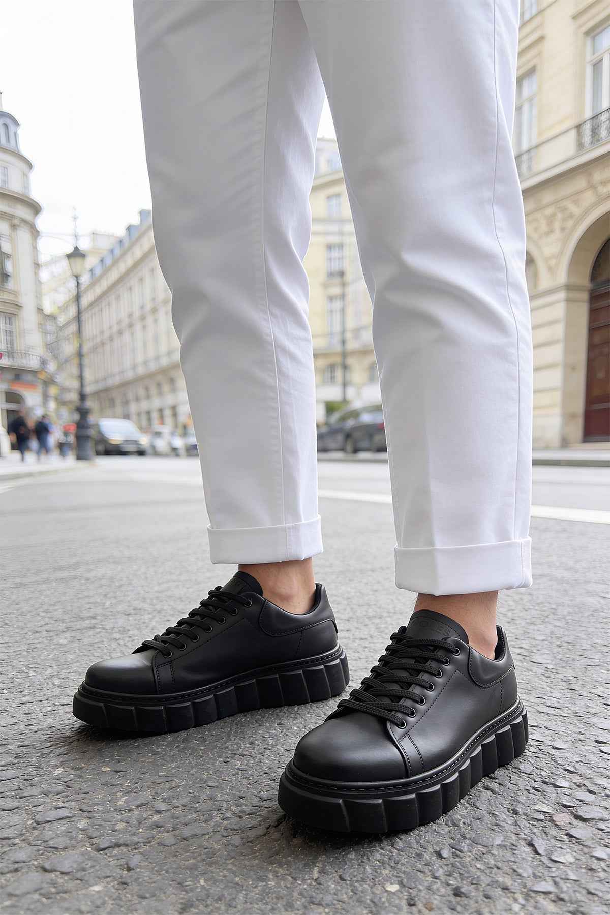Men's casual black sneakers with lace-up front and thick, textured sole