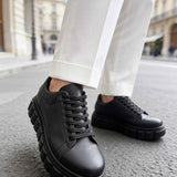 Men's casual black sneakers with lace-up front and thick tread platform sole