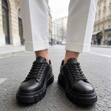 Men's casual black sneakers with lace-up front and elevated tread sole