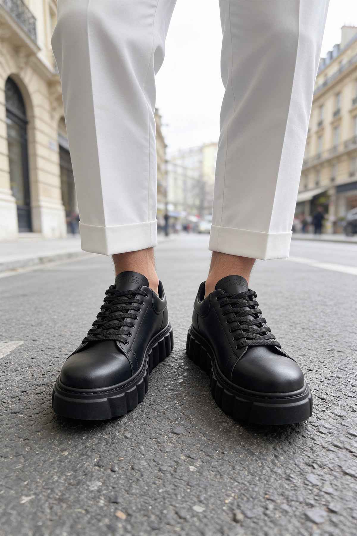 Men's casual black sneakers with lace-up front and elevated tread sole