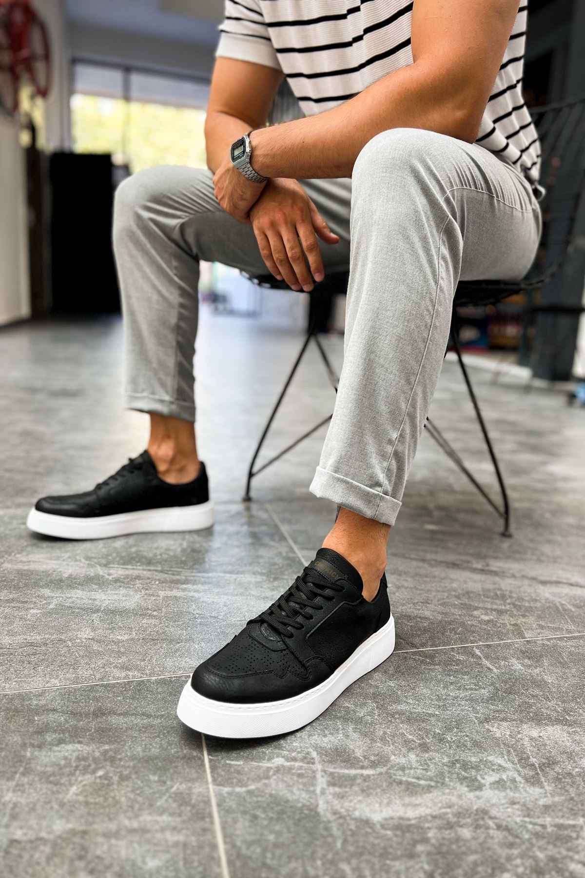 Men's black lace-up sneakers with white rubber sole, side view