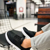 Men's black lace-up sneakers with textured upper and white rubber sole