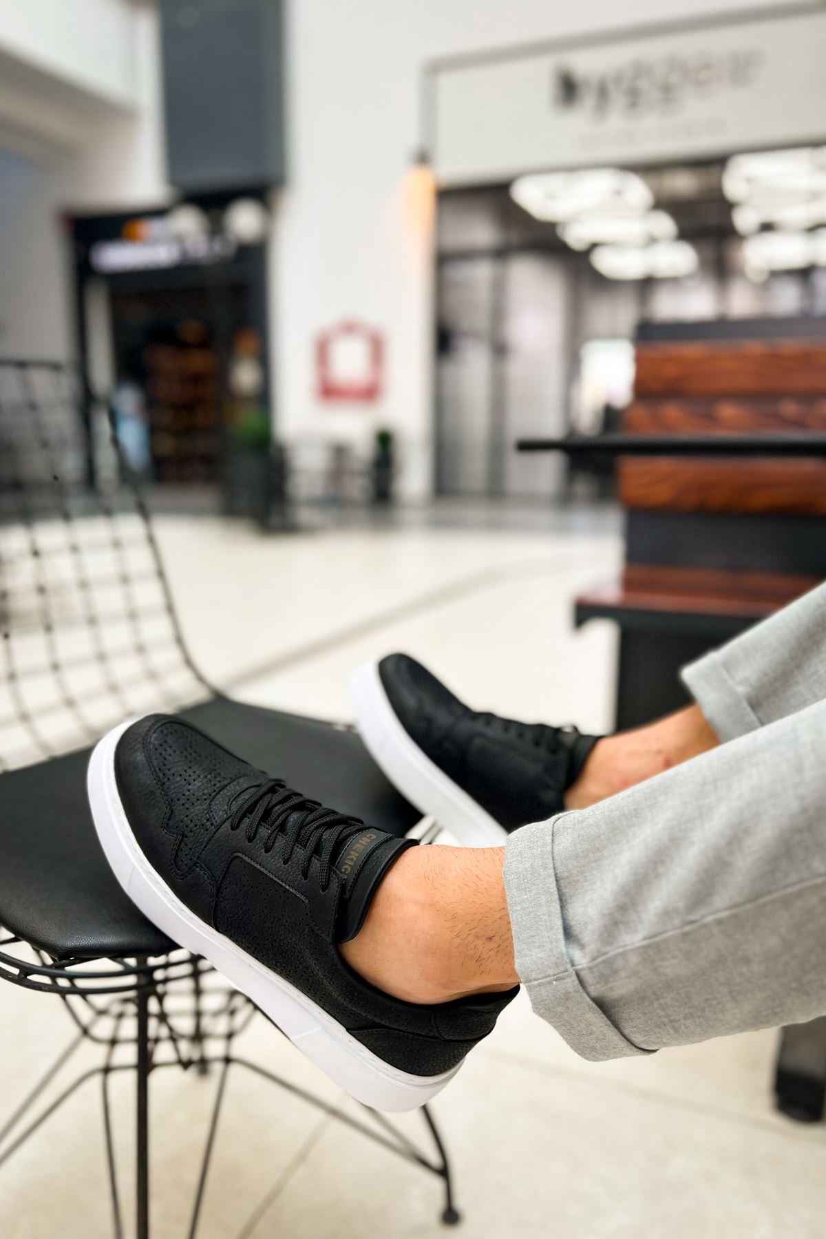 Men's black lace-up sneakers with textured upper and white rubber sole
