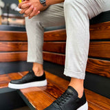 Men's black lace-up sneakers with white rubber sole, angled view