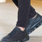 Men's casual black lace-up sneakers with textured sidewall and thick tread sole