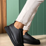 Black casual sneakers with textured upper and side pull-tab