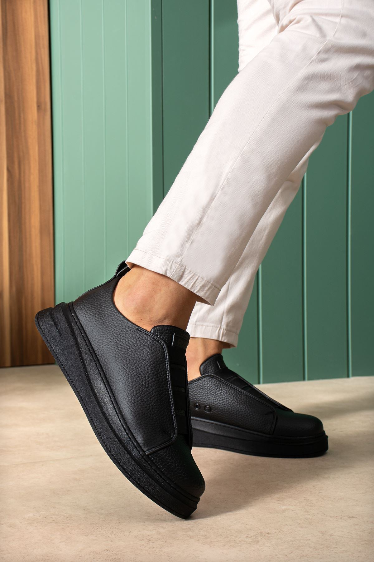 Black casual sneakers with textured upper and side pull-tab