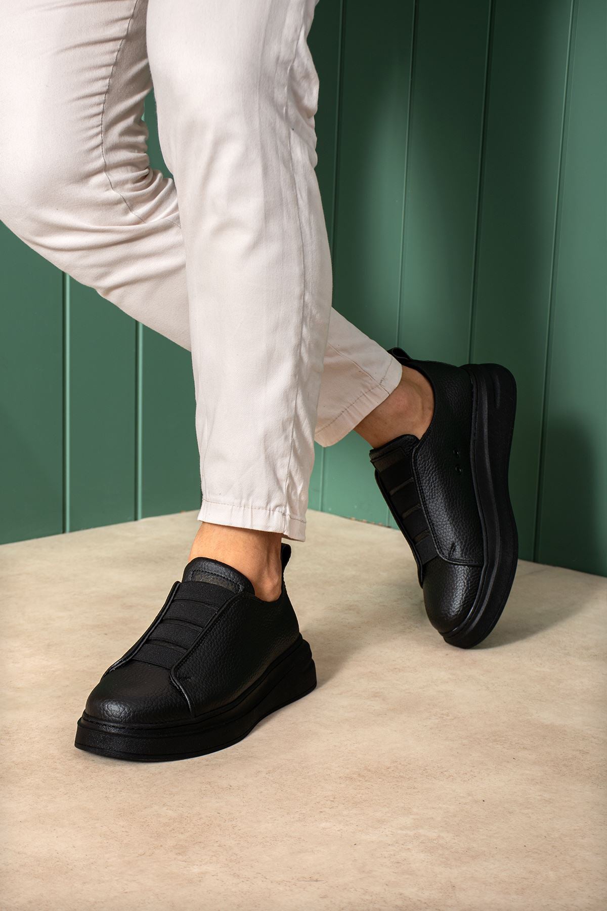 Black casual sneakers with wide side strap and thick rubber sole