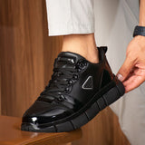 Black leather-look casual sneakers with lace-up front and chunky rubber sole