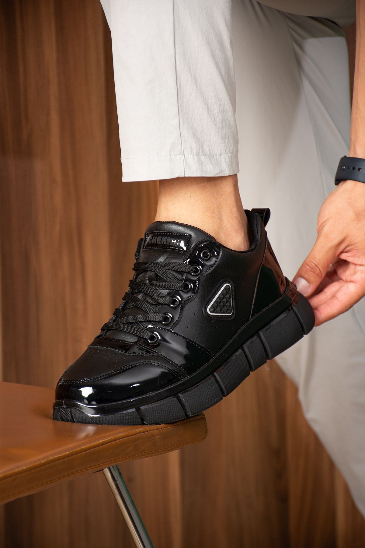 Black leather-look casual sneakers with lace-up front and chunky rubber sole