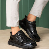 Black lace-up sneakers, front view, glossy toe cap and sport sole