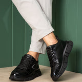 Black sneakers with thick sole and lace-up design, angled side view