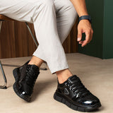 Black lace-up sneakers shown on feet with chunky tread sole