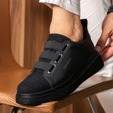 Black low-top sneakers with padded collar and hook-and-loop strap on the side