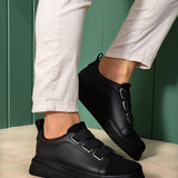 Pair of black low-top sneakers with front strap and cushioned sole