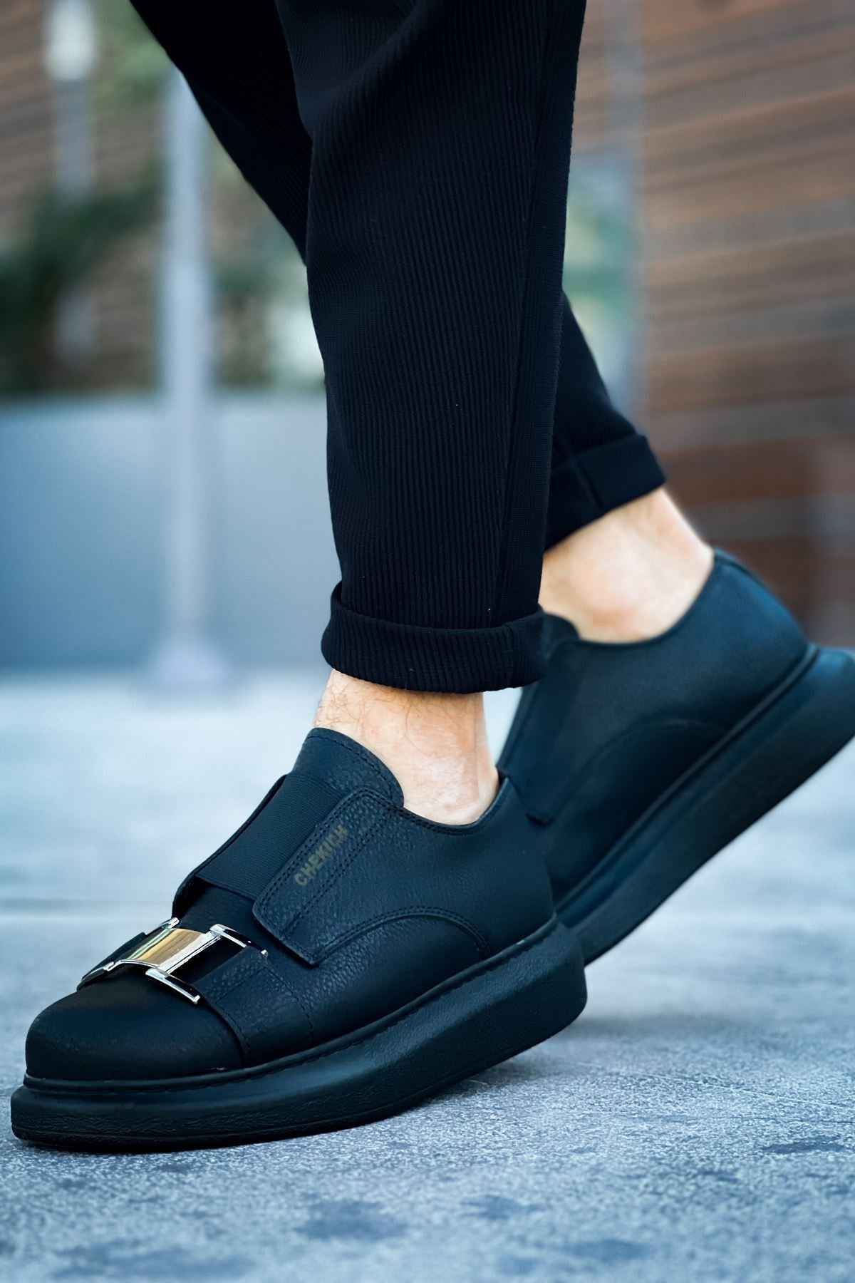 Black casual sneakers with side buckle strap and smooth leather upper