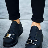Black casual sneakers with adjustable buckle straps and low-profile rubber sole