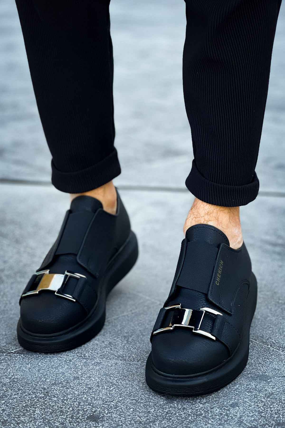 Black casual sneakers with adjustable buckle straps and low-profile rubber sole