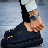 Black casual sneakers with wide buckle strap and textured leather upper, rounded toe