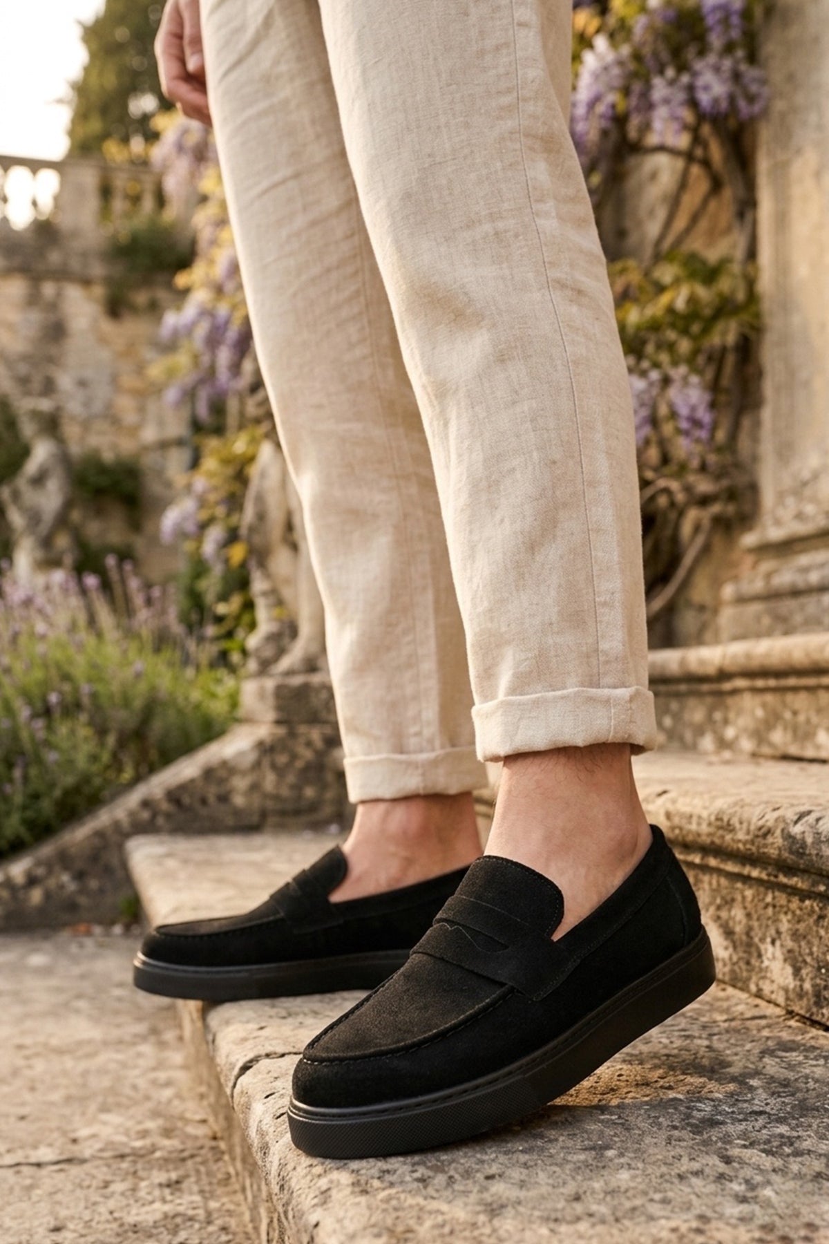 Men's black suede loafer with slip-on design and textured sole edge