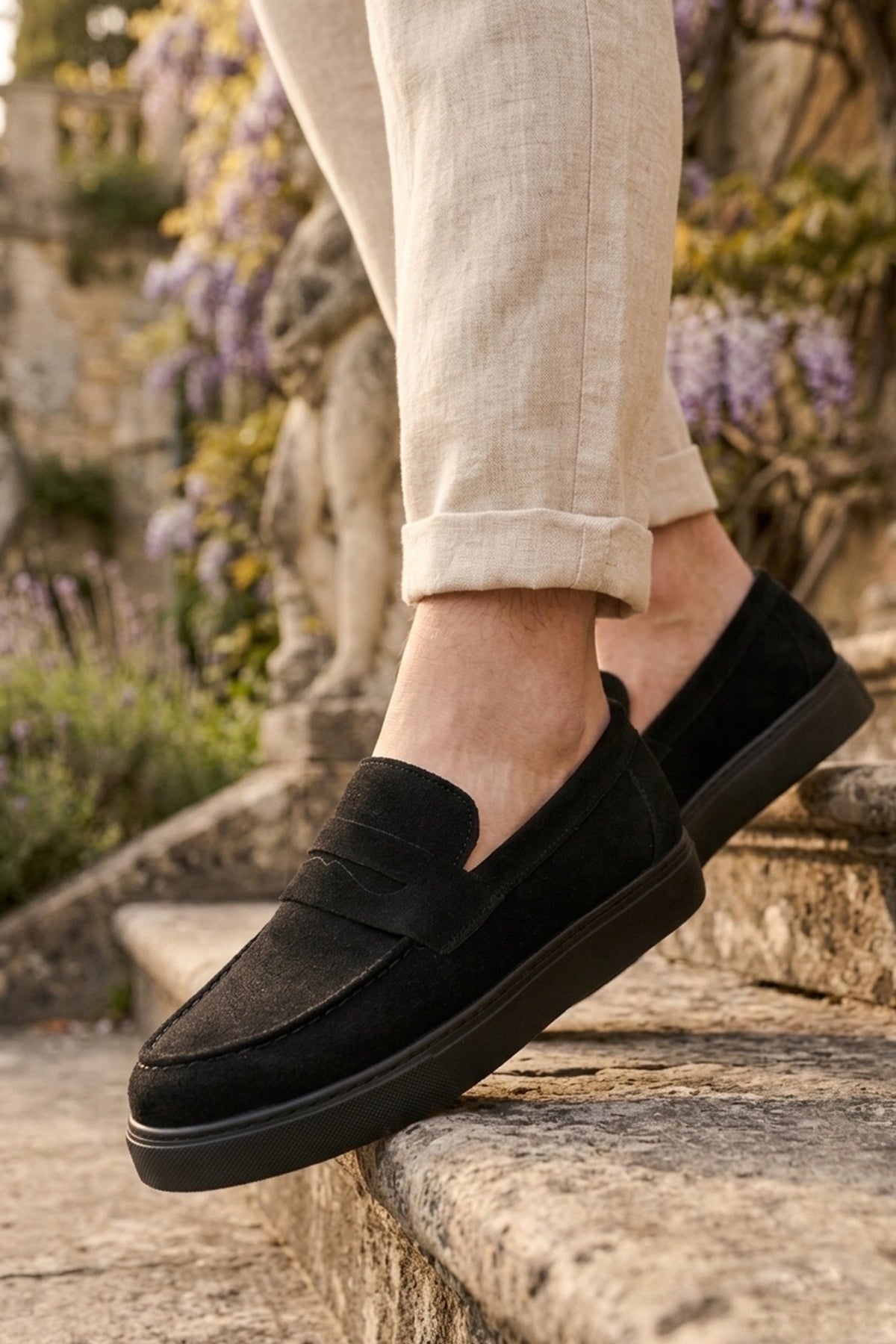 Men's black suede loafer with low platform sole and moc-style detailing