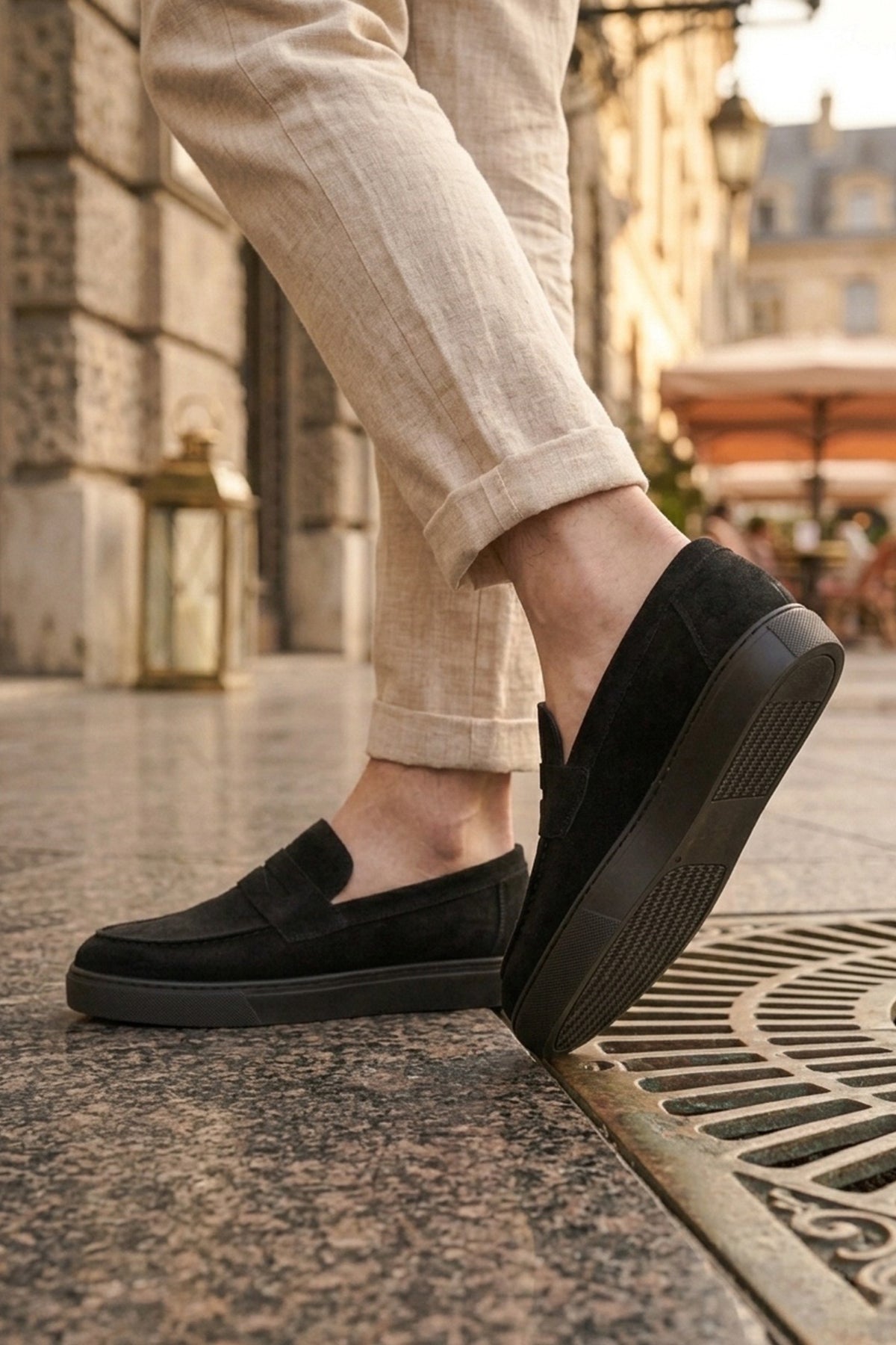 Men's black suede loafer with flexible slip-on fit, showing side tread