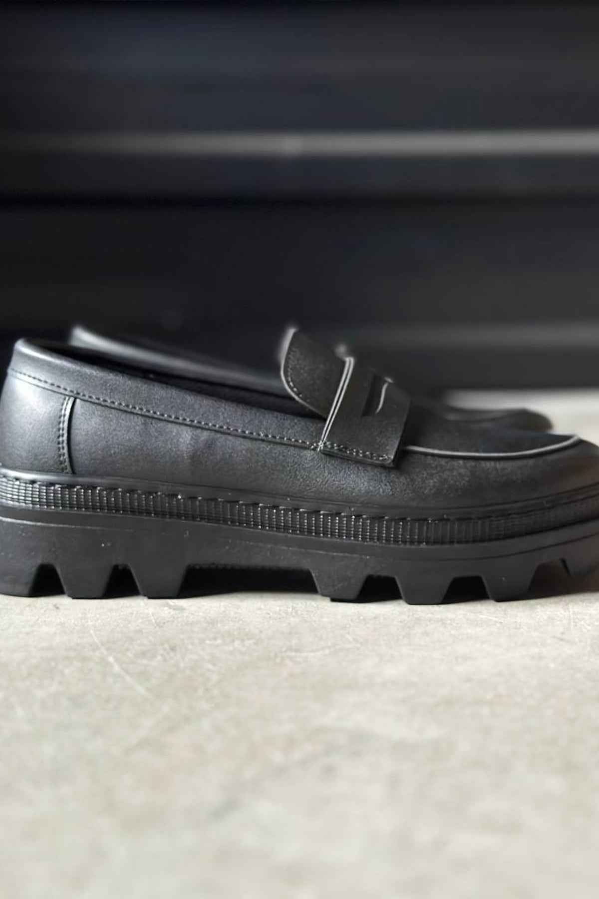 Men's black loafer upper with strap tab and textured rubber sole