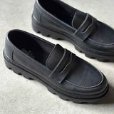 Pair of men's black loafers with strap detail and cushioned lining