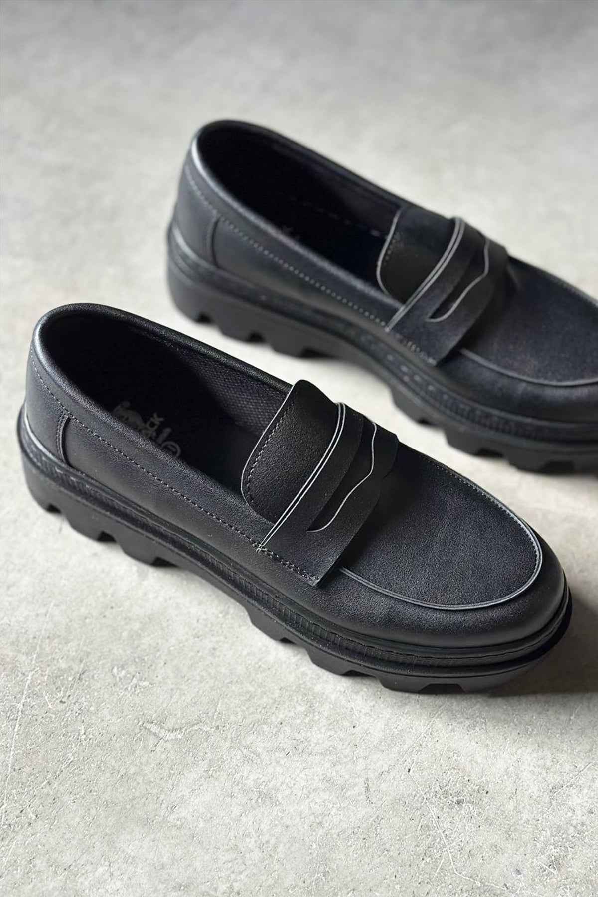 Pair of men's black loafers with strap detail and cushioned lining
