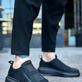 Men's black suede casual sneakers with lace-less slip-on design and side stitching