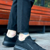 Men's dark suede casual sneakers, side view with stitched logo detail