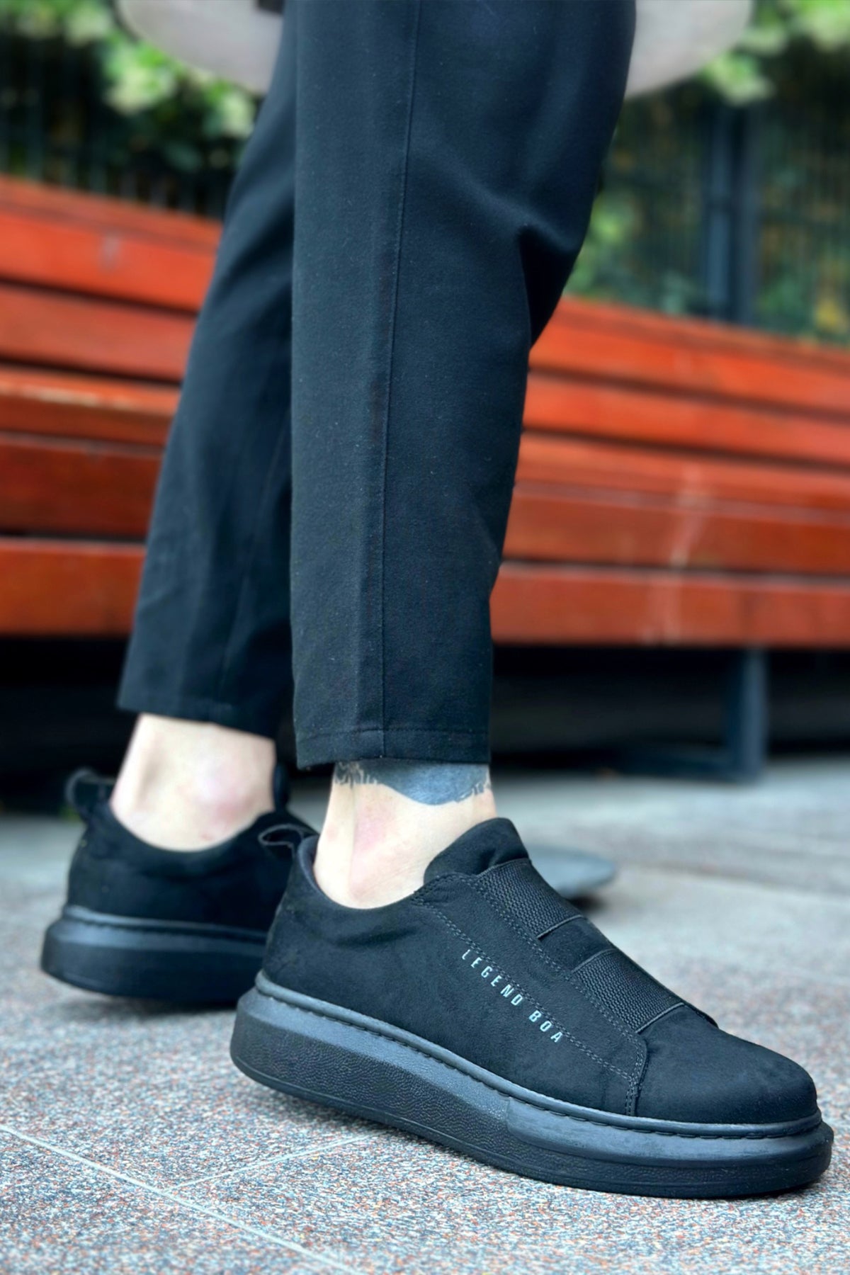 Men's dark suede casual sneakers, side view with stitched logo detail