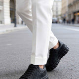 Men's black suede sneakers, lace-up, side profile with textured rubber sole