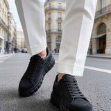 Men's black suede sneakers, lace-up, angled side view with chunky sole