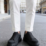 Men's black suede sneakers, lace-up, pair shown from front view with thick sole