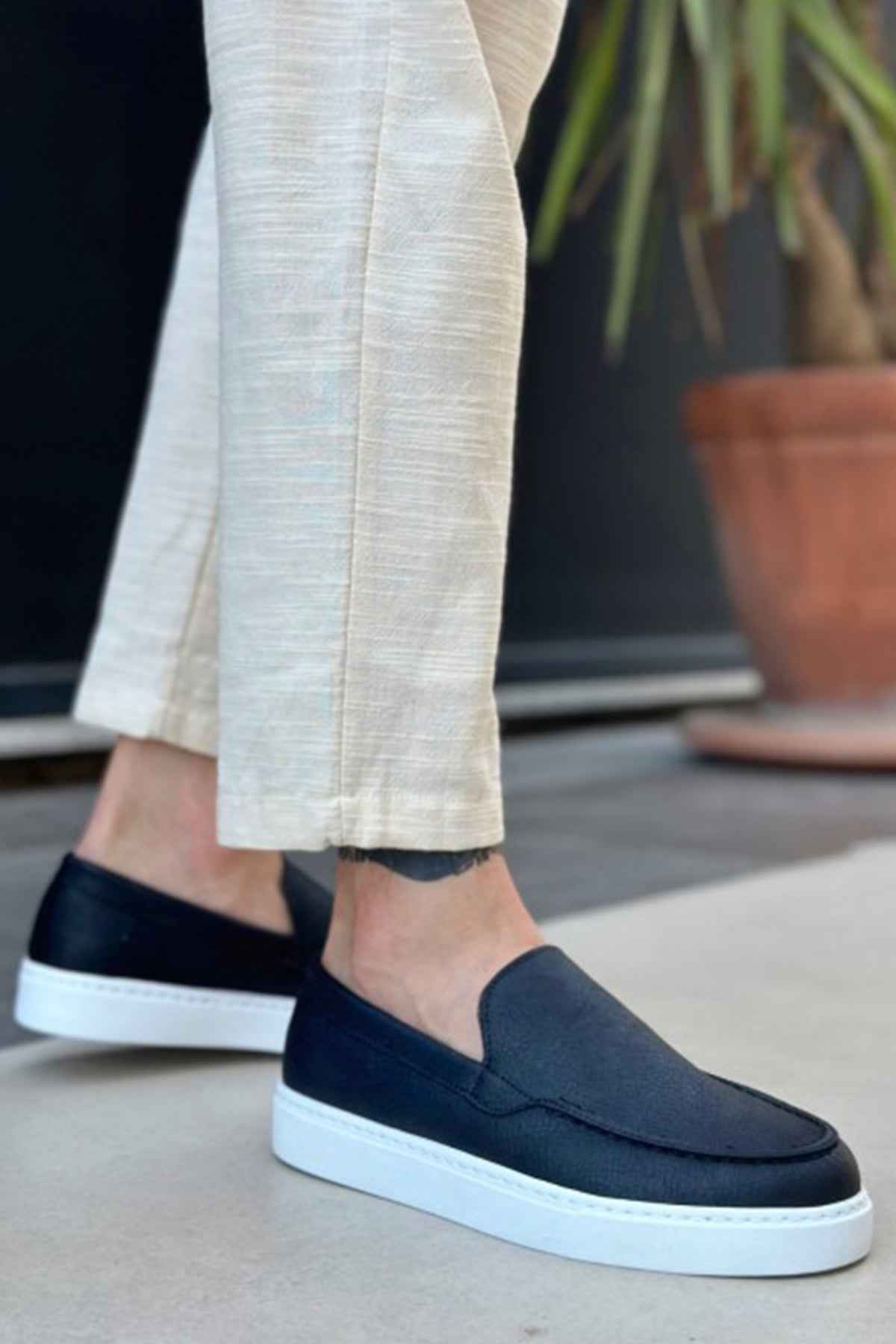 Men's casual black slip-on loafers with white soles