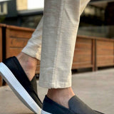 Men's casual black loafers with white soles, slip-on style