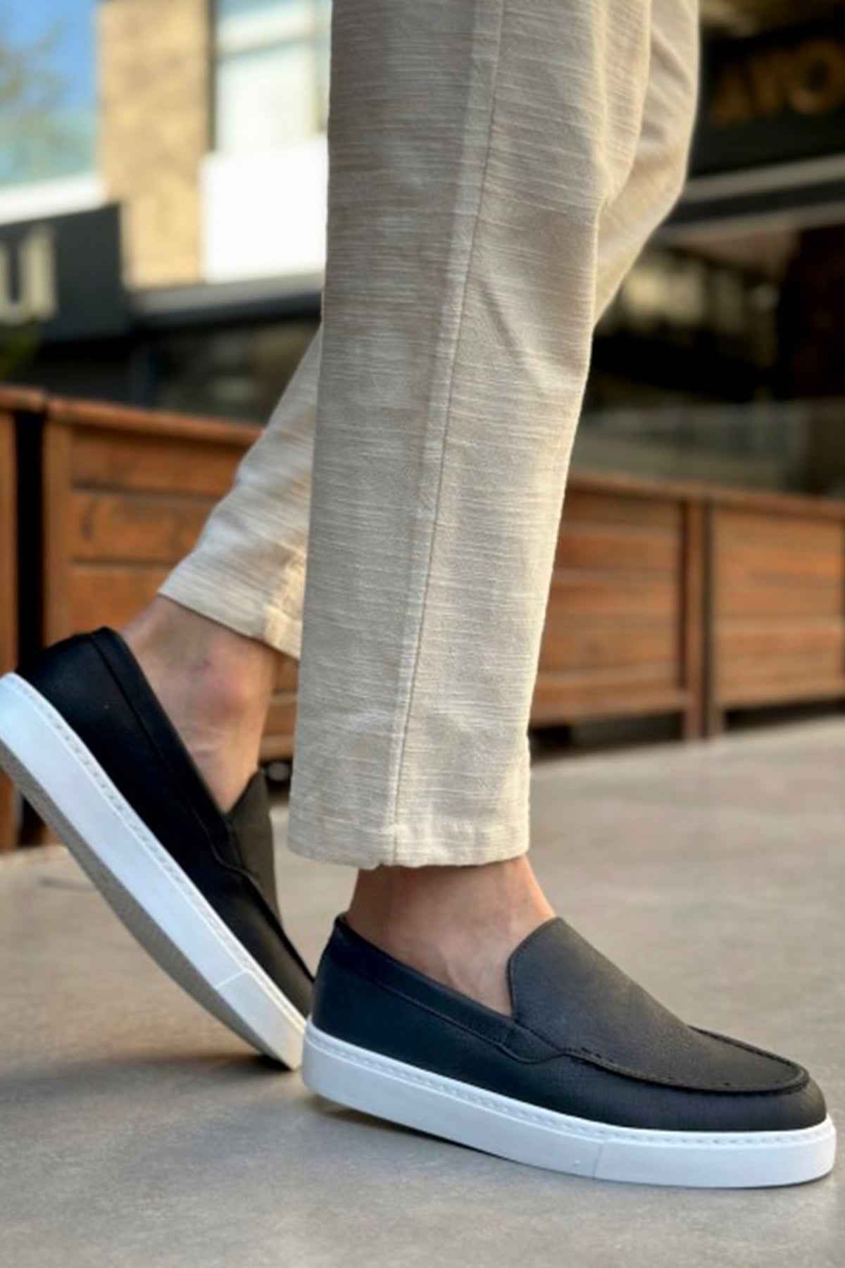 Men's casual black loafers with white soles, slip-on style
